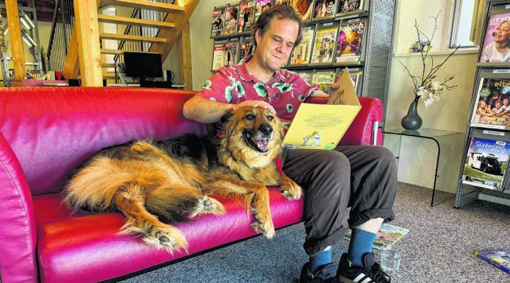 Journalist Gregor Szyndler liest Lesehund Boy eine Geschichte vor – eine Streicheleinheit fehlt nicht. Foto: zVg