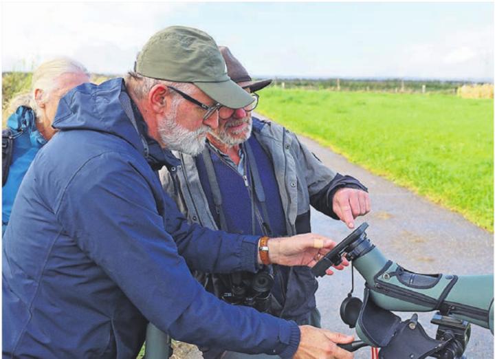 Mit Objektiv und Smartphone: Die Experten vom NVO bestimmen eine Vogelart. Foto: Alan Heckel